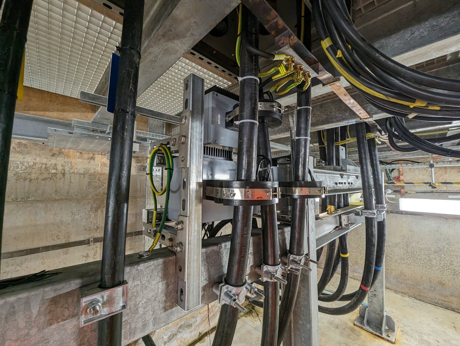 Split-core current transformers with passive sensors fitted around HV cables in a substation cable cellar
