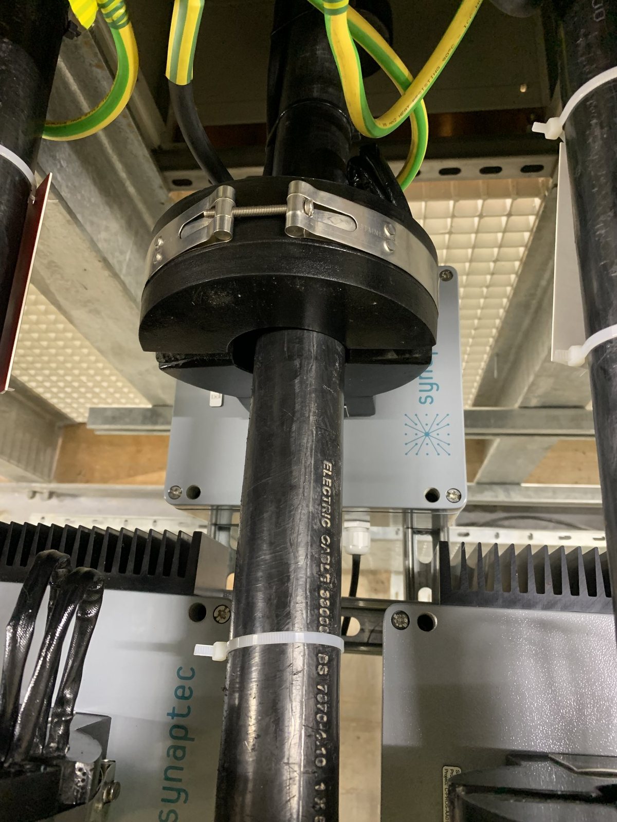 Split-core current transformer on an HV cable, with its passive sensor mounted behind